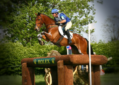 man jumping bay horse